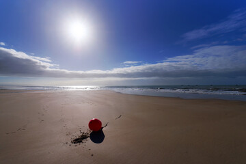 Mooring buoy on the beach of Pirou-Plage in Cotentin coast	
