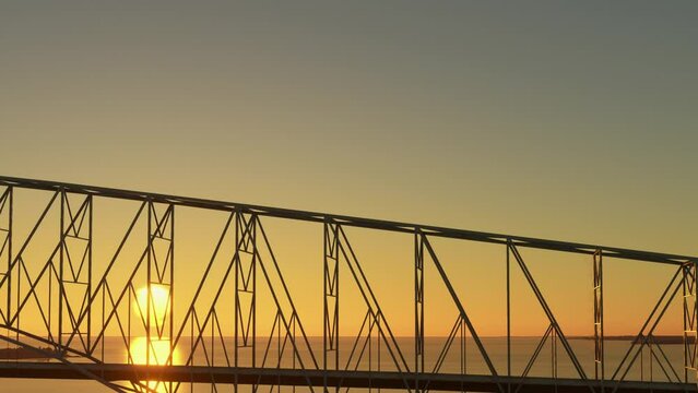 Side aerial drone shot at sunset of the Francis Scott Key Bridge - Baltimore and Dundalk in Maryland. United States