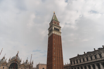Wide-angle view from the iconic San Marco Square in Venice on a cloudy day. Campanile di San Marco,...