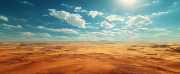 Golden dunes and blue sky in vast desert landscape at sunset