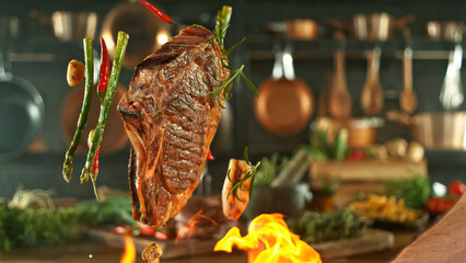 Close-up of tasty beef steak flying above cast-iron grate with fire flames - 768735765