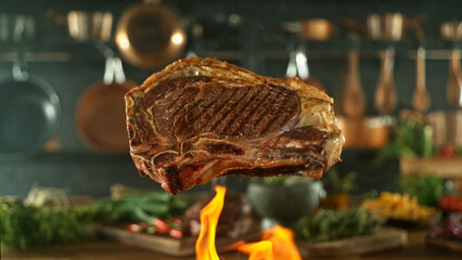 Close-up of tasty beef steak flying above cast-iron grate with fire flames - 768736517