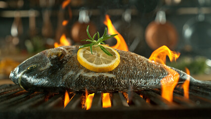 Close-up of tasty fish on cast-iron grate with fire flames