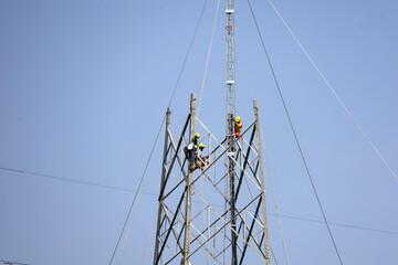 workers on construction crews to work on high ground heavy industry and connection development, distribution electrical concept. Extension of high-voltage towers on blur city background.
Photo Formats
