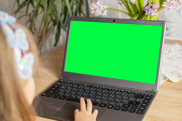 preschool girl studying distance learning course, using computer for self-education and entertainment, monitor with green screen mockup, Parenting in digital age, cyber education, screen time