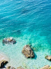 Rocky beach and crystal turquoise water of Ionian Sea in Albania.