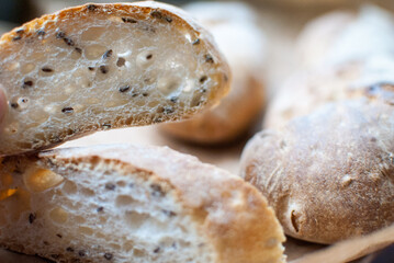 A slice of fresh wheat baguette with seeds. Selective focus. loaf of bread.