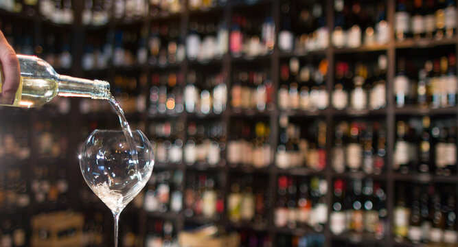 pouring white wine in a glass