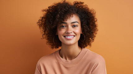 Beautiful african american woman with curly hair on orange background