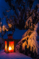 Lantern Illuminates Snowy Scene by Tree