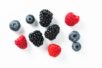 Mix of fresh berries: raspberry, blackberry, blueberry on a white background