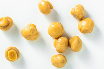 pickled champignon mushrooms on a white background