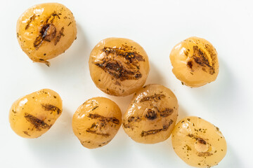 marinated small grilled onions on a white background