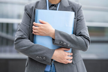 Portrait of happy professional woman holding folder