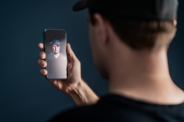 Face recognition with facial scan in phone. Identification and verification to unlock smartphone. Deep fake technology. Man using cellphone. AI mobile tech and biometric id authentication. Data access