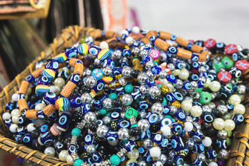Vibrant Turkish souvenir beads, showcasing eye motifs and assorted shapes. Vivid blues and eclectic patterns. Street bazaar, Izmir, Turkey (Turkiye)