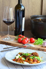 Tomatoes, garlic, parsley and wine on a wooden board