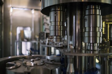 Automatic filling machine at beverage factory. Industrial business concept.