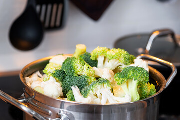 Broccoli and cauliflower are steamed in a saucepan - healthy diet, baby food, cooking in a steamer	
