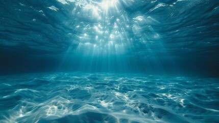 Underwater background featuring a deep blue sea with beautiful light rays piercing through the water - obrazy, fototapety, plakaty