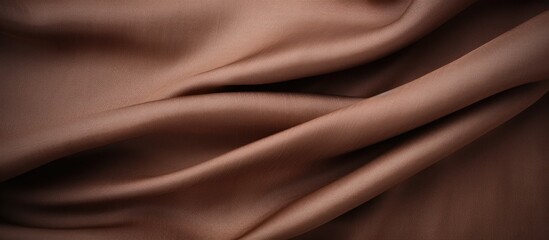 Close up of a textured brown fabric with a very long line running across, creating a unique pattern. Top view of the rich brown fabric background.