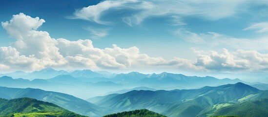 Fototapeta premium Picturesque view of green mountains dotted with trees, under a beautiful sky with fluffy clouds, in celebration of World Environment Day