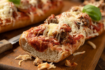 Sausage pizza bread on cutting board - 768779747