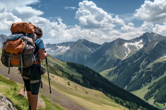 hiker with backpack overlooking a high mountain pass