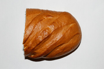 Isolated half loaf of bread on white background, top view