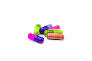 Multicoloured vibrant pills or capsules on white background. Spring lack of vitamins