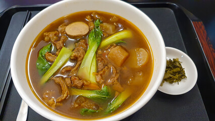 Taiwanese Beef Noodle Soup With Suan Cai (Pickled Mustard Greens) On Tray.