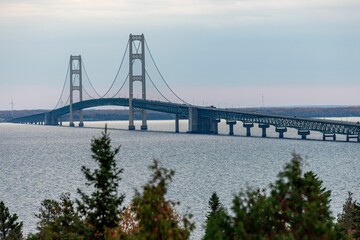 Aerial view of the Mackinac Bridge in Michigan, surrounded by forests