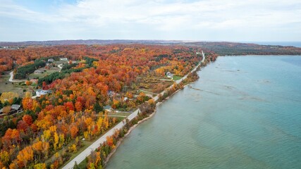 Aerial view of an autumnal scene of trees on the banks of a Cut River, in Michigan