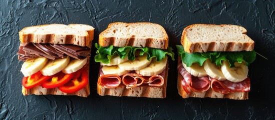 Assorted sandwiches with salami, chocolate, banana, cream cheese, and red pepper for morning or...