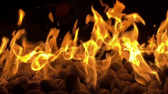 Slow morion of the burning fire against the dark black background