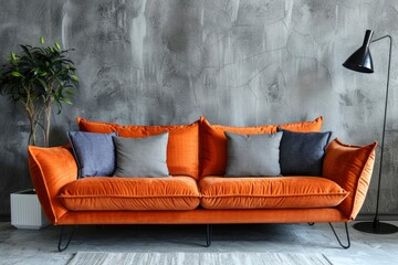 Bold orange sofa flanked by cozy gray pillows, paired with an indoor plant and modern lighting,...