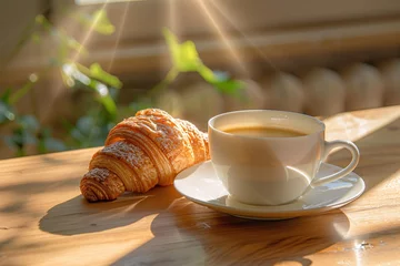 Fotobehang a croissant and a cup of coffee on a table © Georgeta