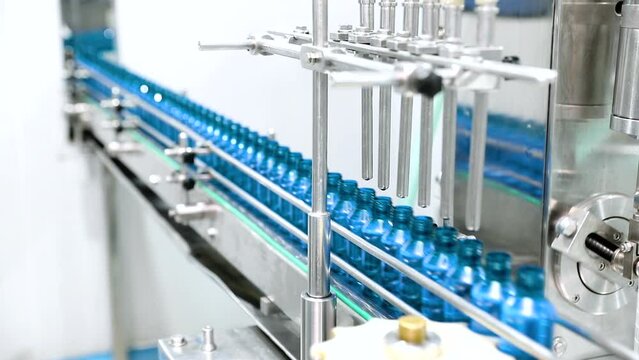 chemical liquid sanitiser gel fills in bottles aqueous soap hand wash detergent medicine production line filling making process in a plastic transparent bottle manufacturing factory	
