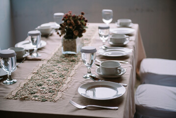 A luxurious dining table with no food served is prepared for lunch in a restaurant
