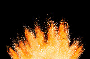 Abstract powder splatted background. orange powder explosion on black background. Colored cloud. Colorful dust explode. Paint Holi