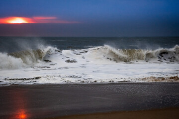 Colorful and Moody Atlantic Ocean Wave at Sunrise in Winter, Lots of Sea Foam