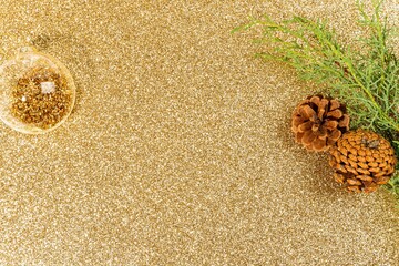 Festive and glittery Christmas background featuring golden decorations and ornaments
