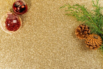 Festive and glittery Christmas background featuring golden decorations and ornaments