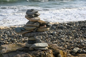 Stunning beach shore with stone stacked in a tower