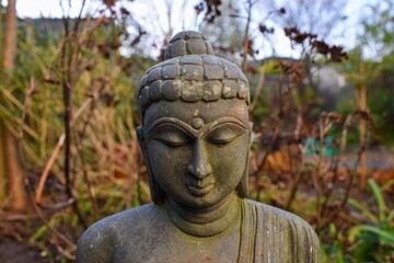 Close up of a buddha statue in a meditation garden