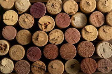 Variety of wine corks are displayed in a creative pattern.