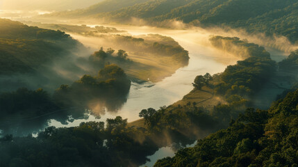 A captivating mist veils the winding river valley, illuminated by a golden sunrise among rolling hills and forests