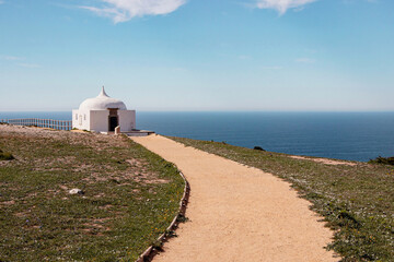 small white church at blue coastline at Sesimbra, Portugal - 768814966