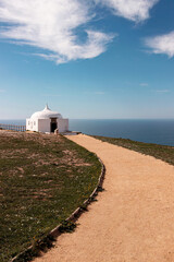 small white church at blue coastline at Sesimbra, Portugal - 768815114
