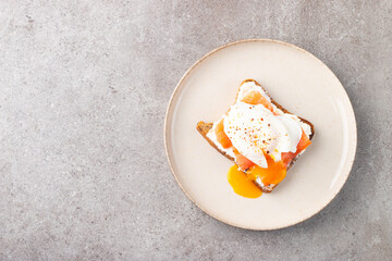 Poached egg on salmon and cheese toast. Breakfast food concept. Open sandwich. 